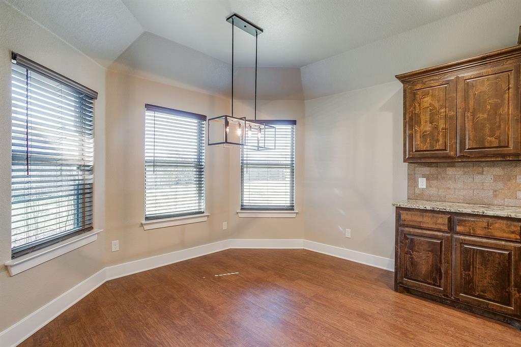110 Hummingbird Drive Weatherford, TX 76085 - Photo 11 of 38 a view of an empty room with window and wooden floor