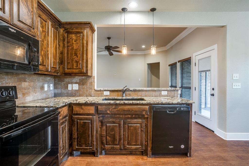 110 Hummingbird Drive Weatherford, TX 76085 - Photo 16 of 38 a kitchen with a sink and cabinets