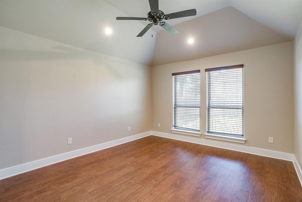 110 Hummingbird Drive Weatherford, TX 76085 - Photo 17 of 38 an empty room with wooden floor ceiling fan and windows