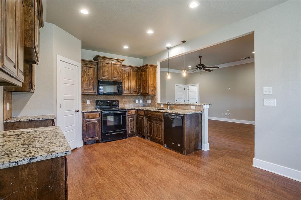 110 Hummingbird Drive Weatherford, TX 76085 - Photo 22 of 38 a kitchen with stainless steel appliances granite countertop a refrigerator stove and oven