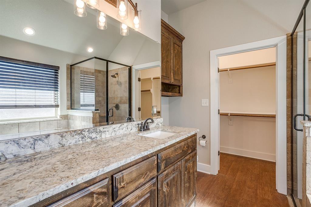 110 Hummingbird Drive Weatherford, TX 76085 - Photo 23 of 38 a bathroom with a granite countertop sink and a mirror