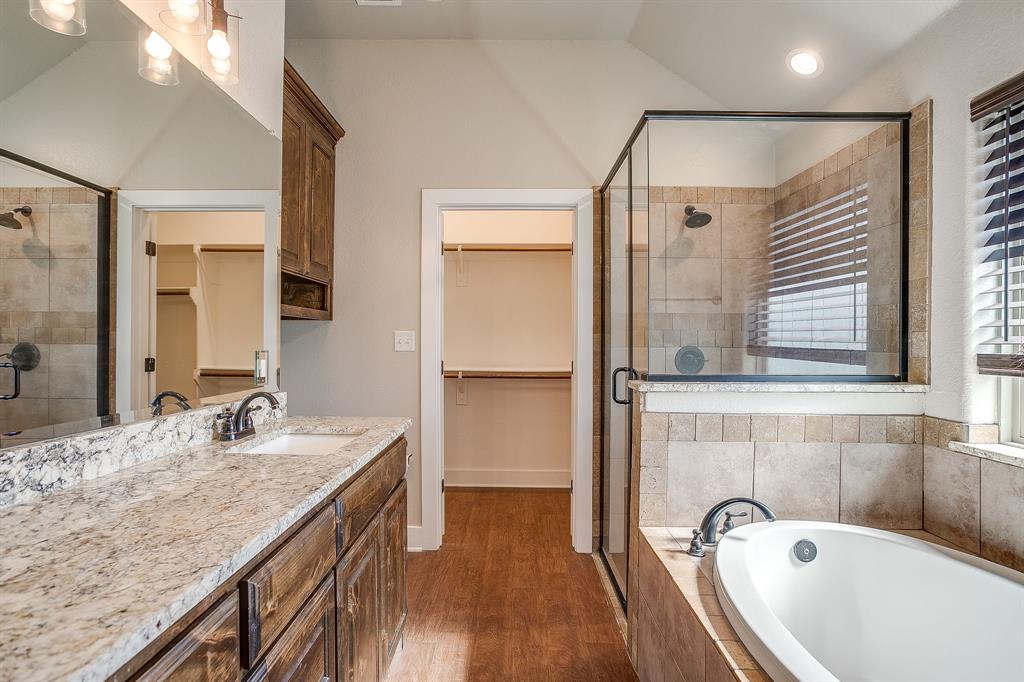 110 Hummingbird Drive Weatherford, TX 76085 - Photo 24 of 38 a bathroom with a granite countertop tub sink and mirror