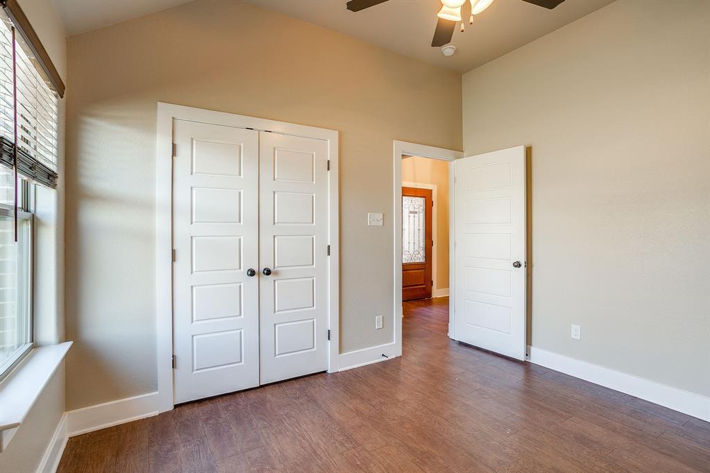 110 Hummingbird Drive Weatherford, TX 76085 - Photo 30 of 38 a view of an empty room with wooden floor and a window