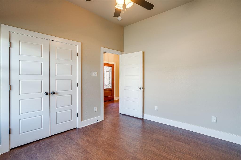 110 Hummingbird Drive Weatherford, TX 76085 - Photo 31 of 38 a view of an empty room and wooden floor chandelier fan