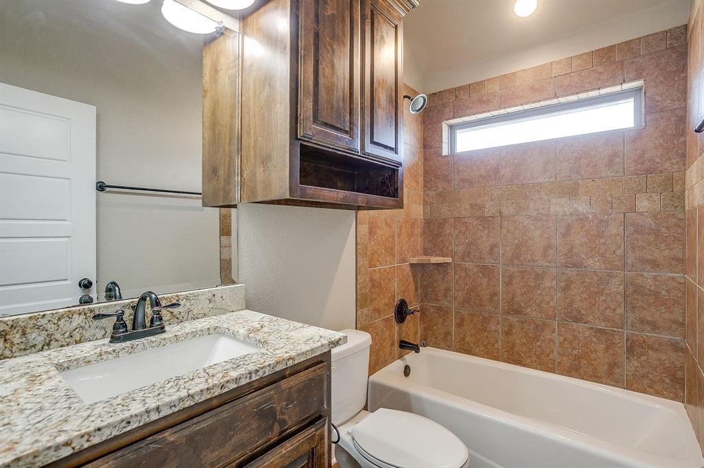 110 Hummingbird Drive Weatherford, TX 76085 - Photo 32 of 38 a bathroom with a granite countertop sink toilet and bathtub