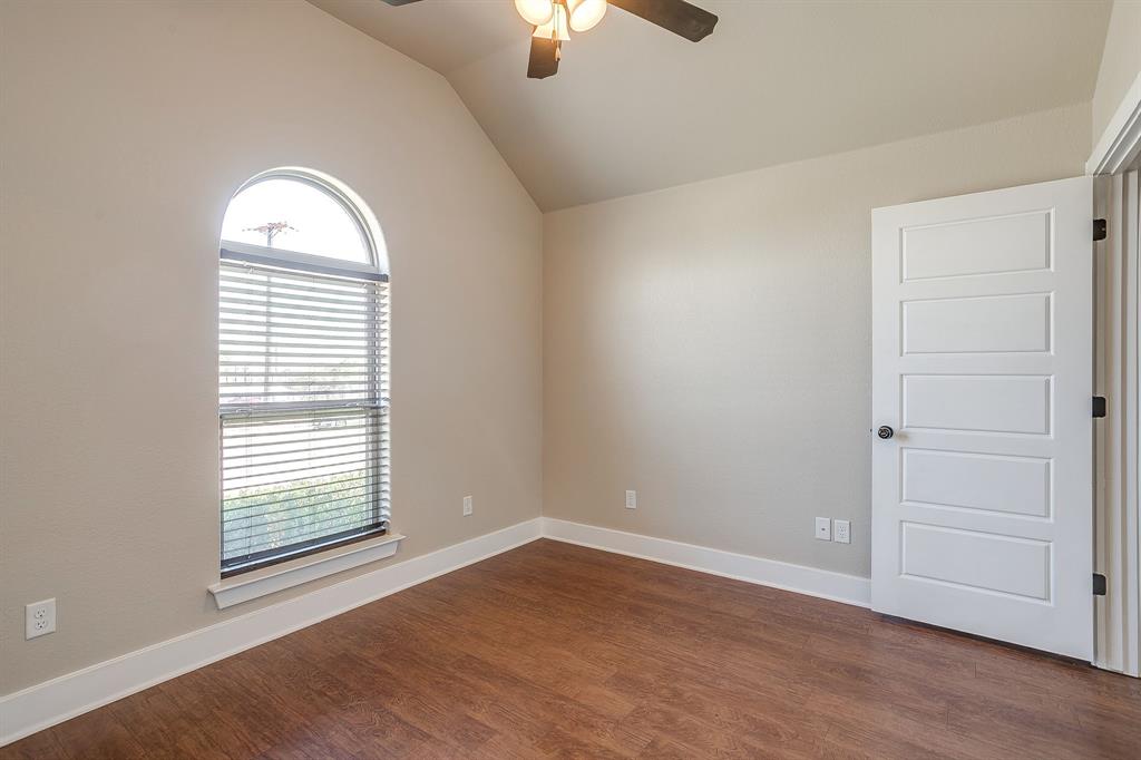 110 Hummingbird Drive Weatherford, TX 76085 - Photo 35 of 38 an empty room with wooden floor chandelier fan and windows