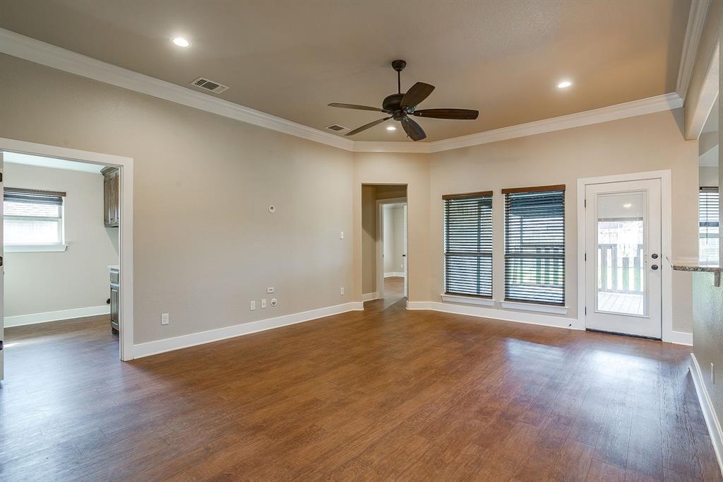 110 Hummingbird Drive Weatherford, TX 76085 - Photo 4 of 38 a view of an empty room with a window and wooden floor