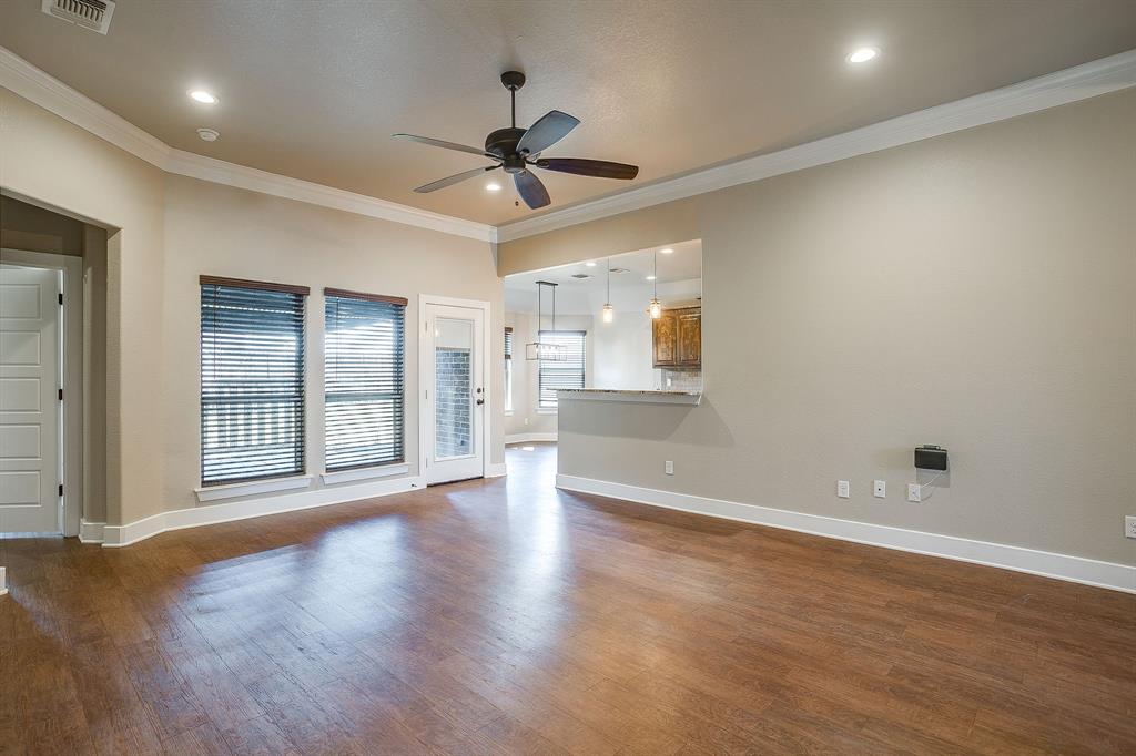110 Hummingbird Drive Weatherford, TX 76085 - Photo 7 of 38 an empty room with wooden floor fan and windows