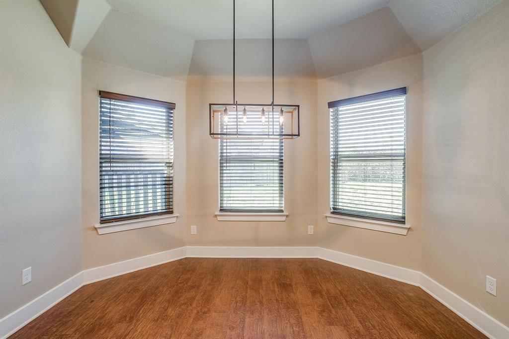 110 Hummingbird Drive Weatherford, TX 76085 - Photo 9 of 38 an empty room with wooden floor and windows