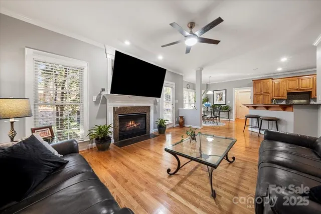 a living room with furniture a fireplace and a flat screen tv