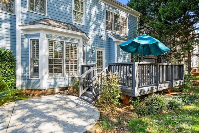 a front view of a house with a yard glass top table and chairs