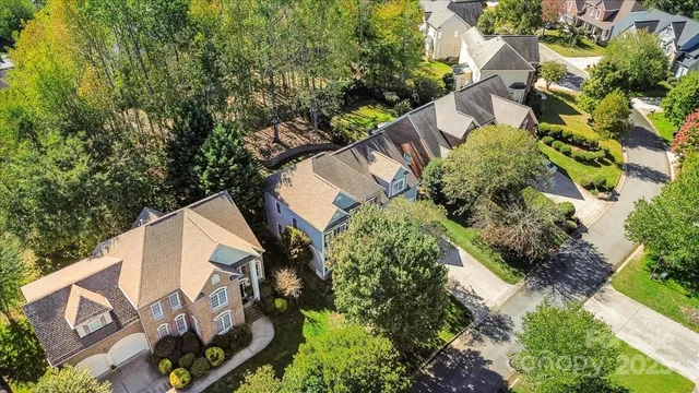 an aerial view of a house with a yard and plants