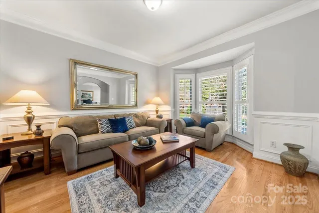 a living room with furniture a rug and a window