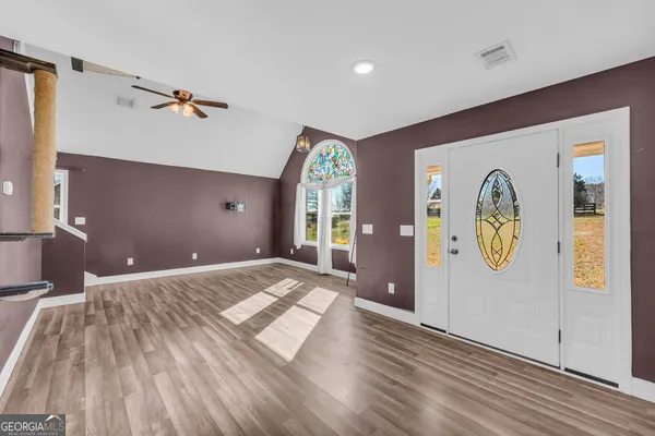 a view of an entryway with wooden floor