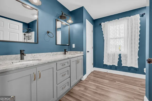 a bathroom with a double vanity sink and a mirror