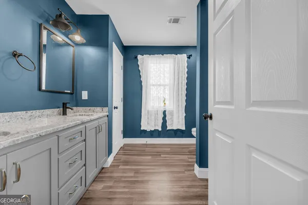 a spacious bathroom with a double vanity sink and a mirror