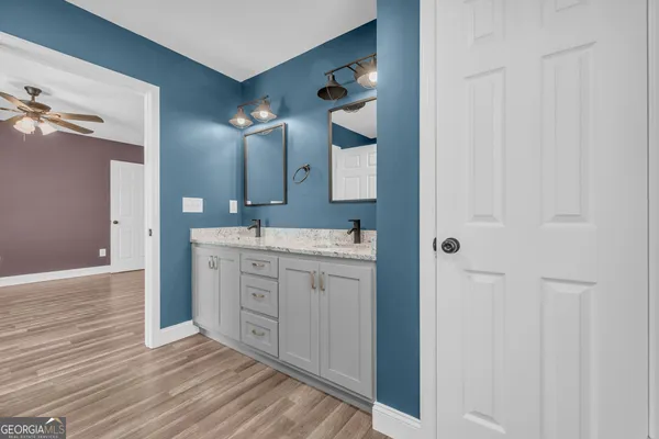 a spacious bathroom with a double vanity sink and a mirror
