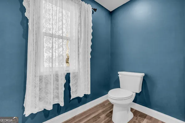 a white toilet sitting next to a bathroom sink