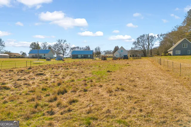 a kitchen with a refrigerator a sink and dishwasher with wooden floor