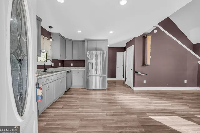 a view of an entryway with wooden floor