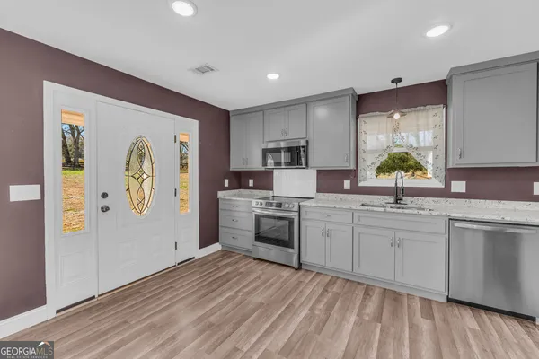 a kitchen with a refrigerator and a sink