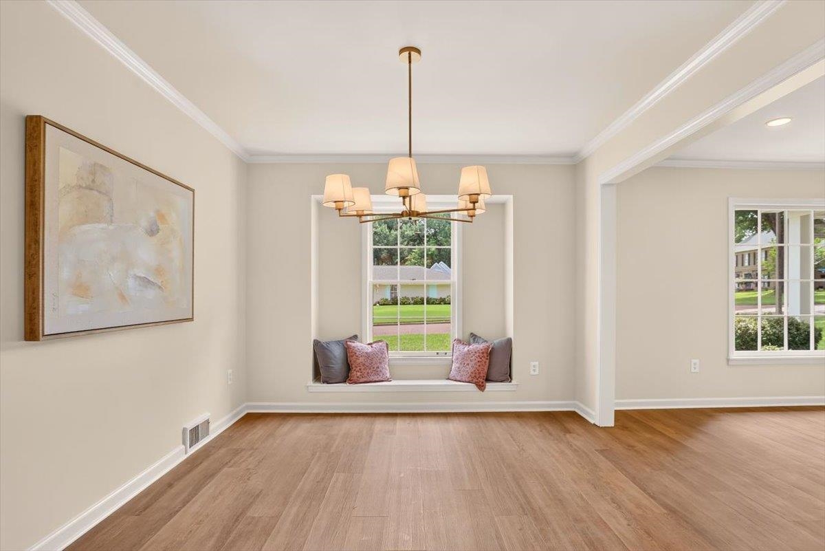 7674 Apple Valley Road Germantown, TN 38138 - Photo 7 of 15 Spacious room featuring wood-finish flooring, a contemporary six-light chandelier, and a built-in window seat