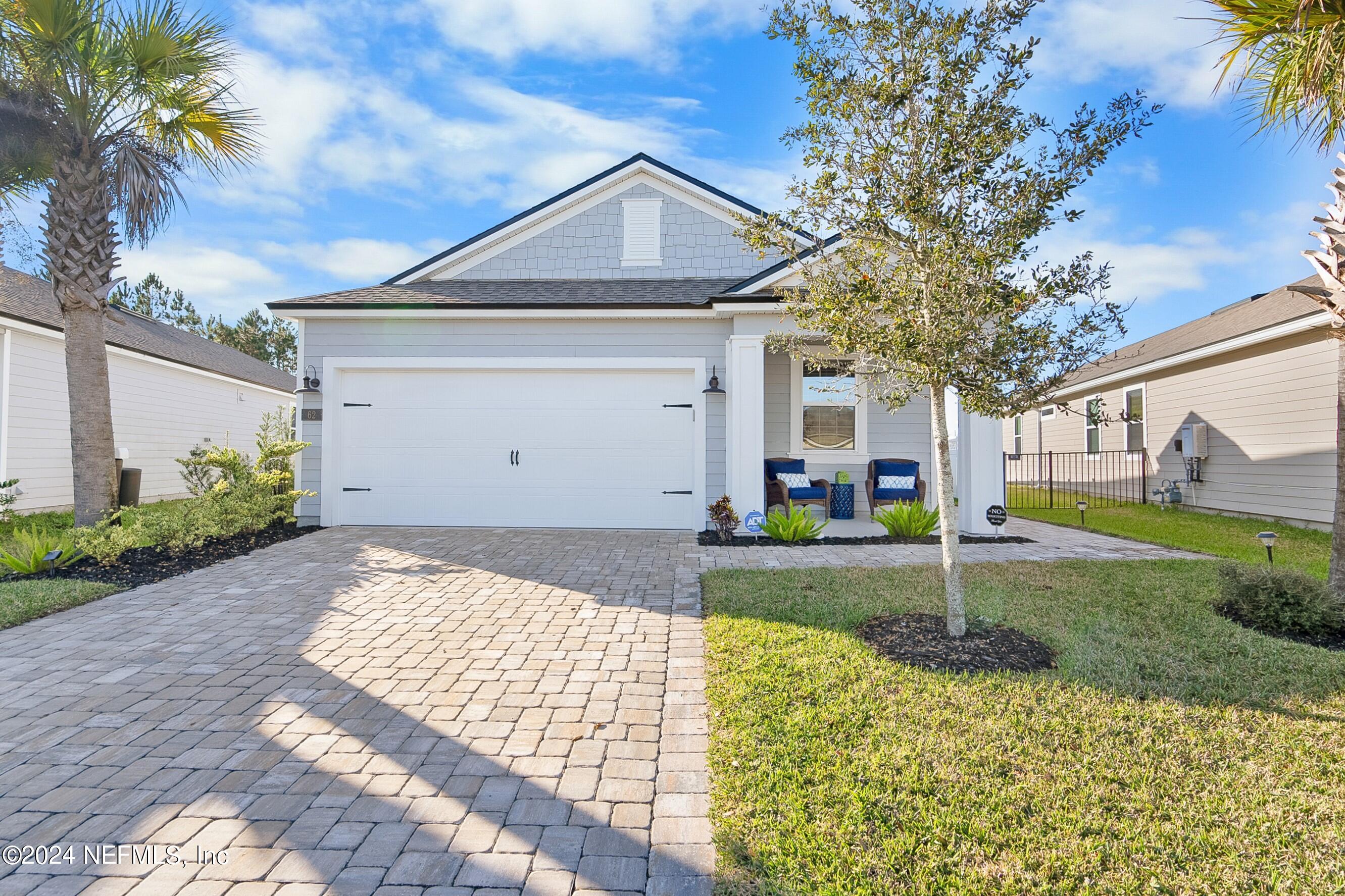 62 Thistleton Way Street St. Augustine, FL 32092 - Photo 1 of 29 a front view of a house with a yard and garage