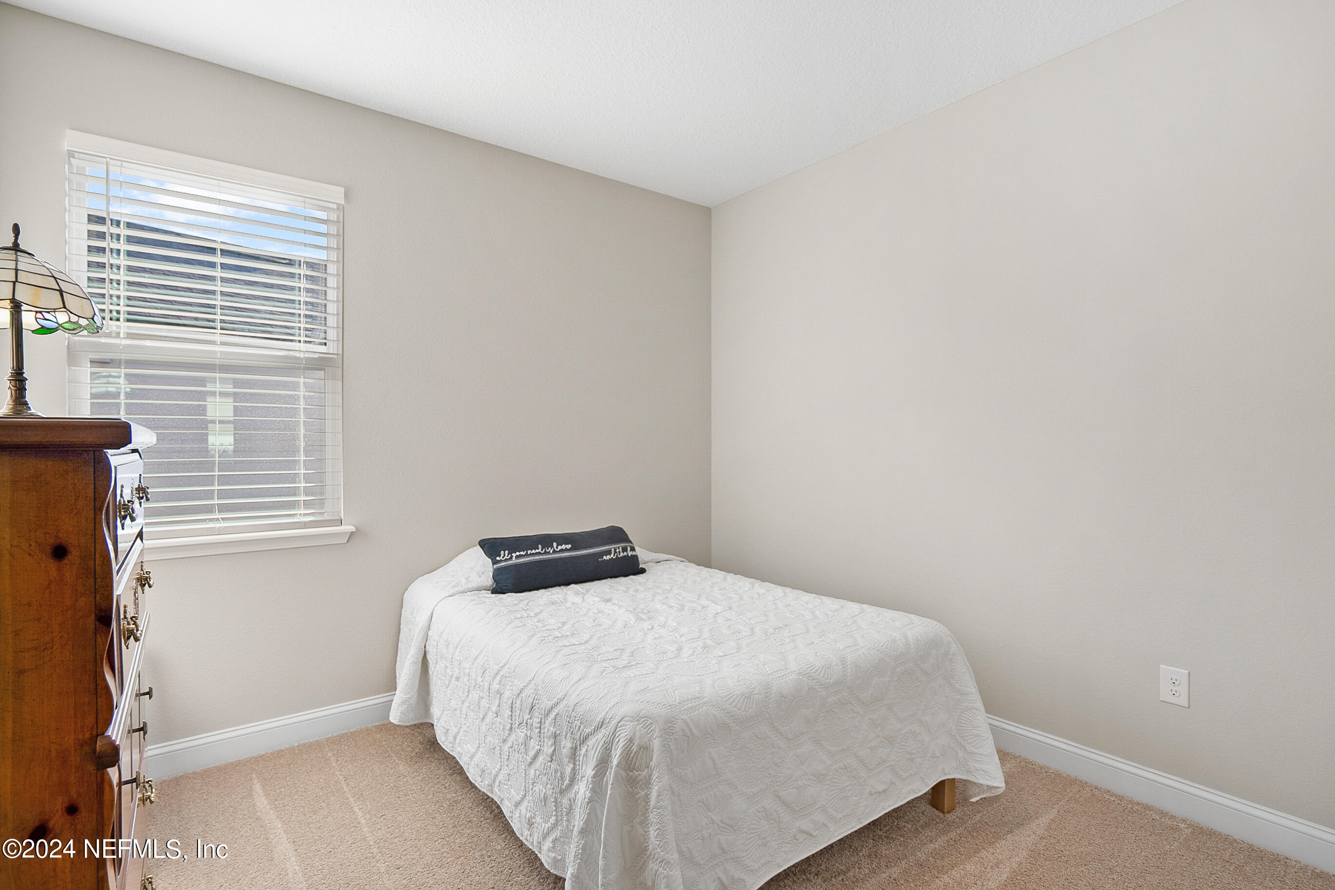 62 Thistleton Way Street St. Augustine, FL 32092 - Photo 18 of 29 a bedroom with a bed and a window