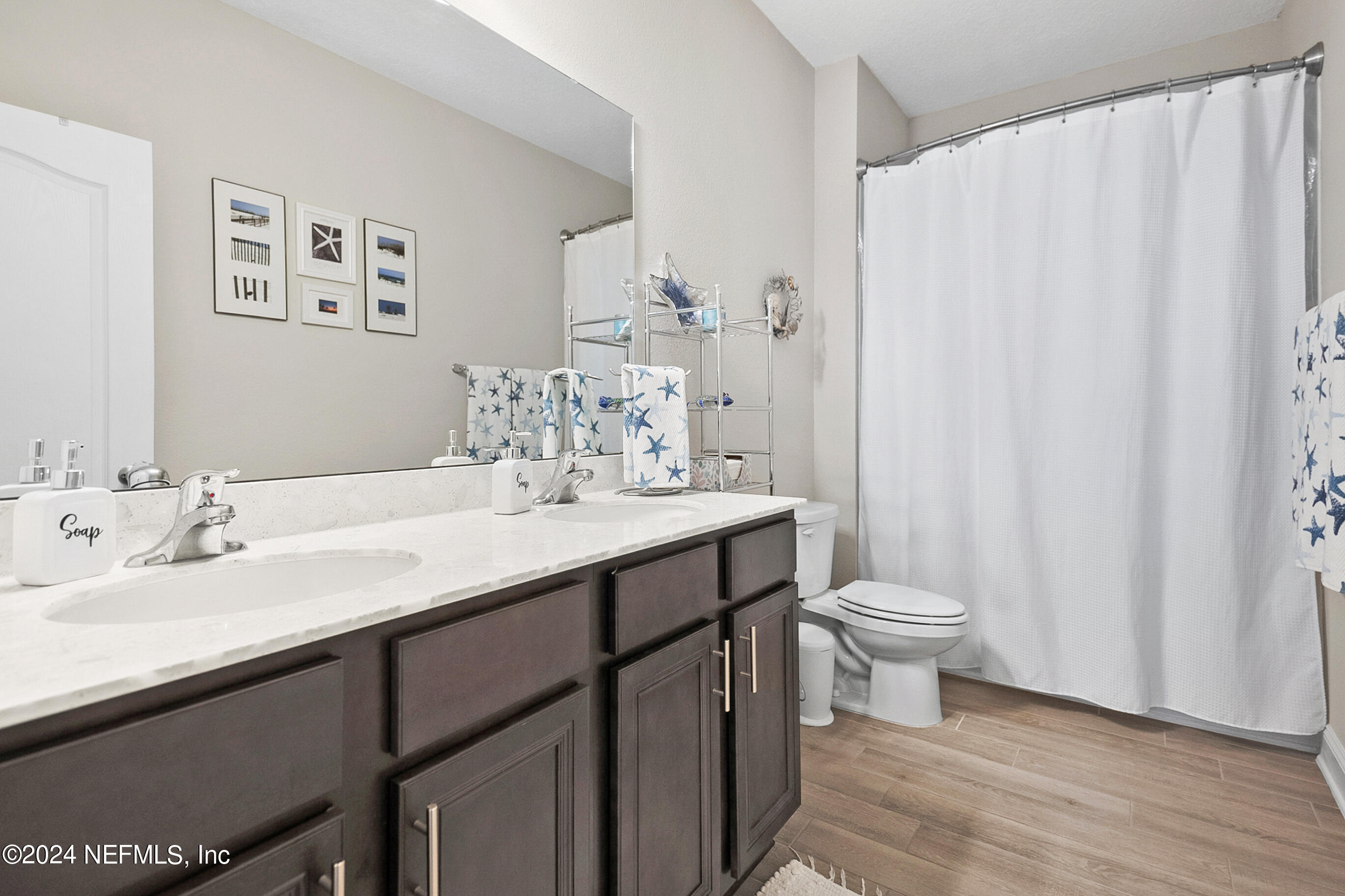 62 Thistleton Way Street St. Augustine, FL 32092 - Photo 19 of 29 a bathroom with a double vanity sink toilet and a mirror