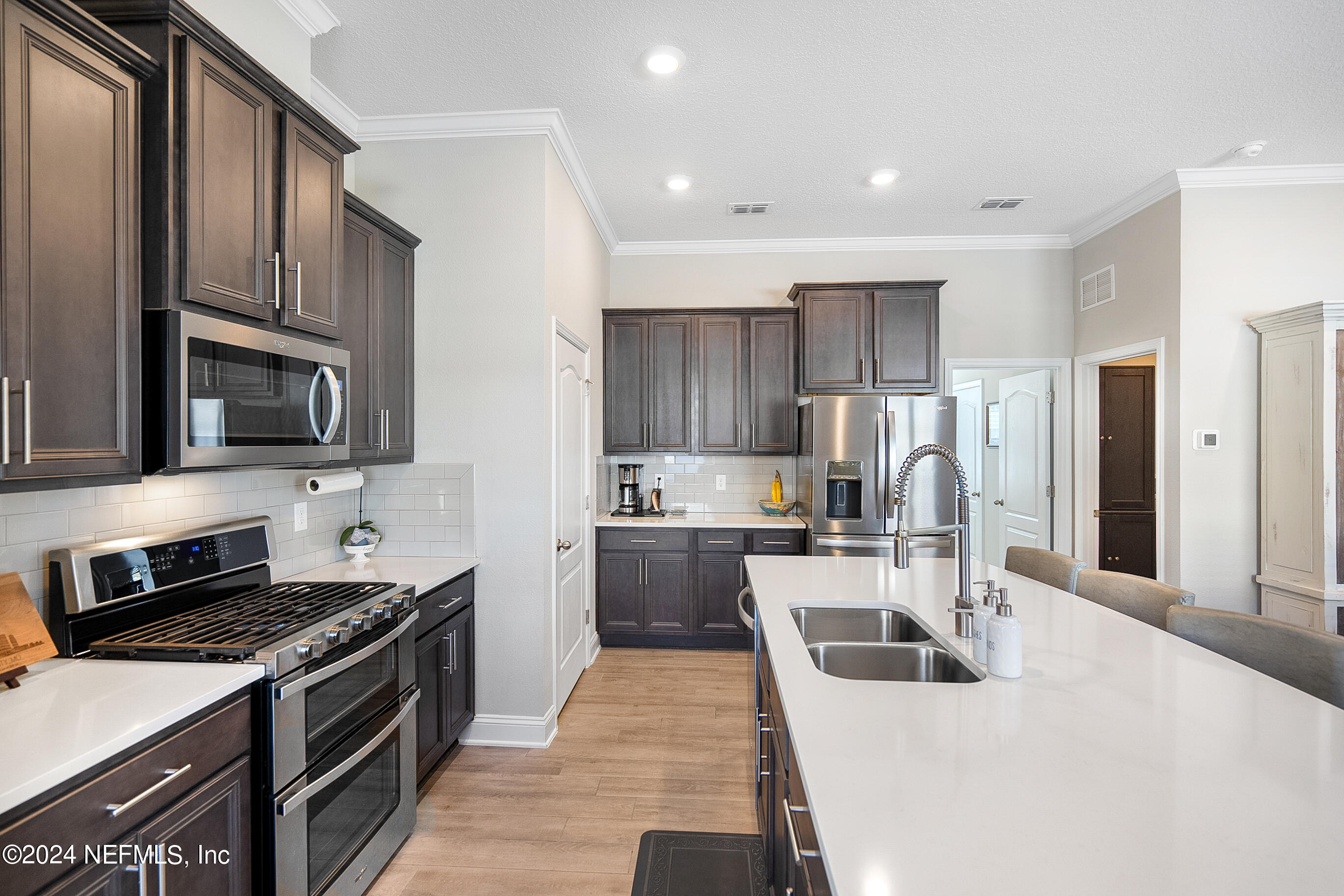 62 Thistleton Way Street St. Augustine, FL 32092 - Photo 7 of 29 a kitchen with stainless steel appliances a stove sink microwave and refrigerator