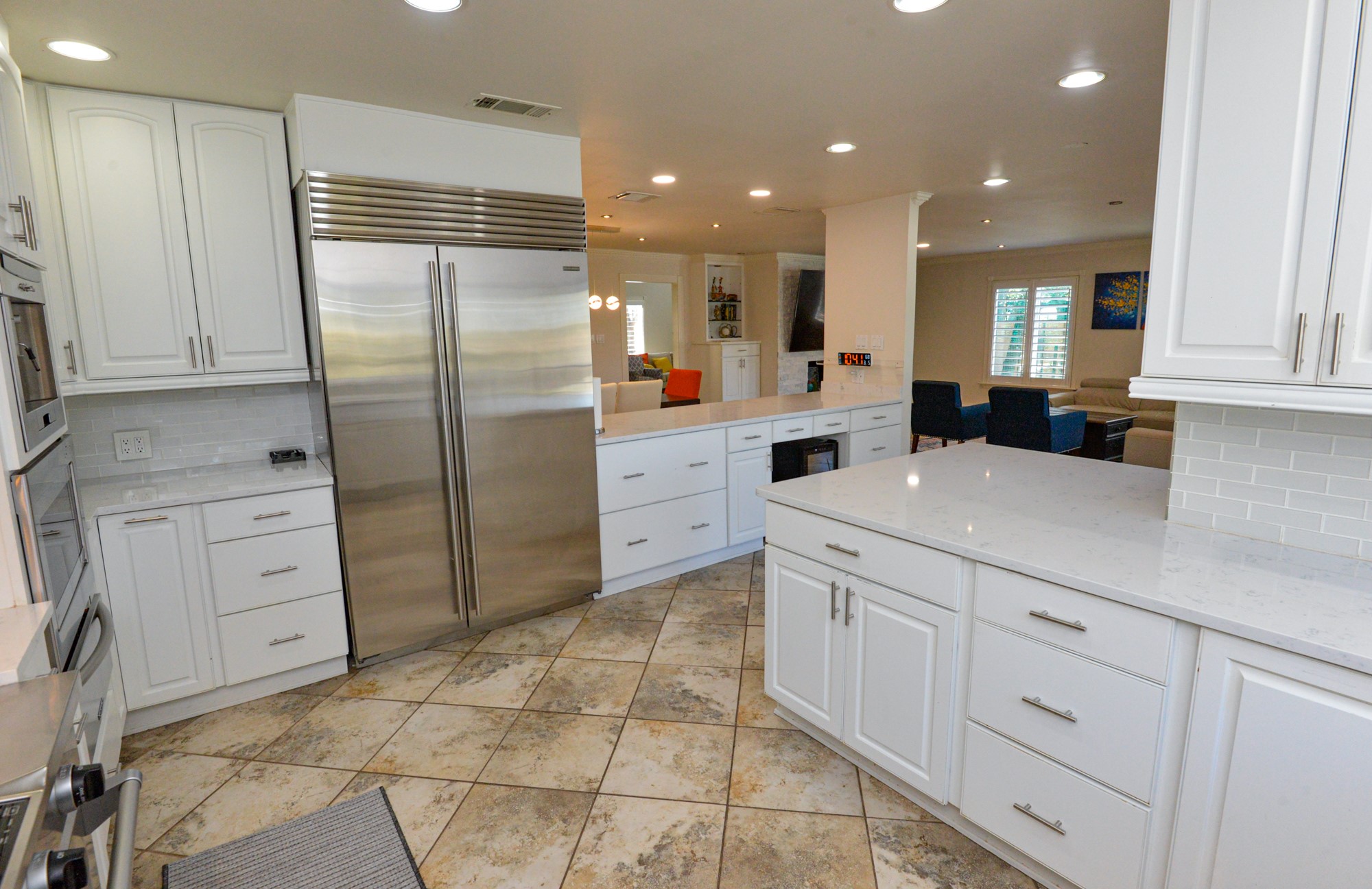 10710 D-K Ranch Road Austin, TX 78759 - Photo 10 of 34 A well-appointed kitchen features stainless steel appliances and ample counter space, flowing into a comfortable living area.
