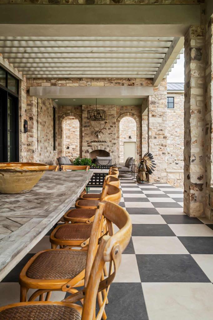 a view of a patio with table and chairs and floor to ceiling window