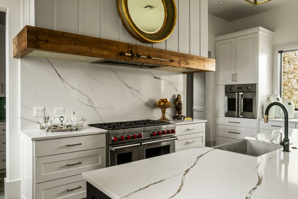 371 Achtzehn Road Fredericksburg, TX 78624 - Photo 19 of 41 a kitchen with a stove a sink and a cabinets