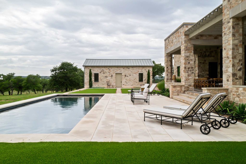 371 Achtzehn Road Fredericksburg, TX 78624 - Photo 26 of 41 a view of a swimming pool with lounge chair