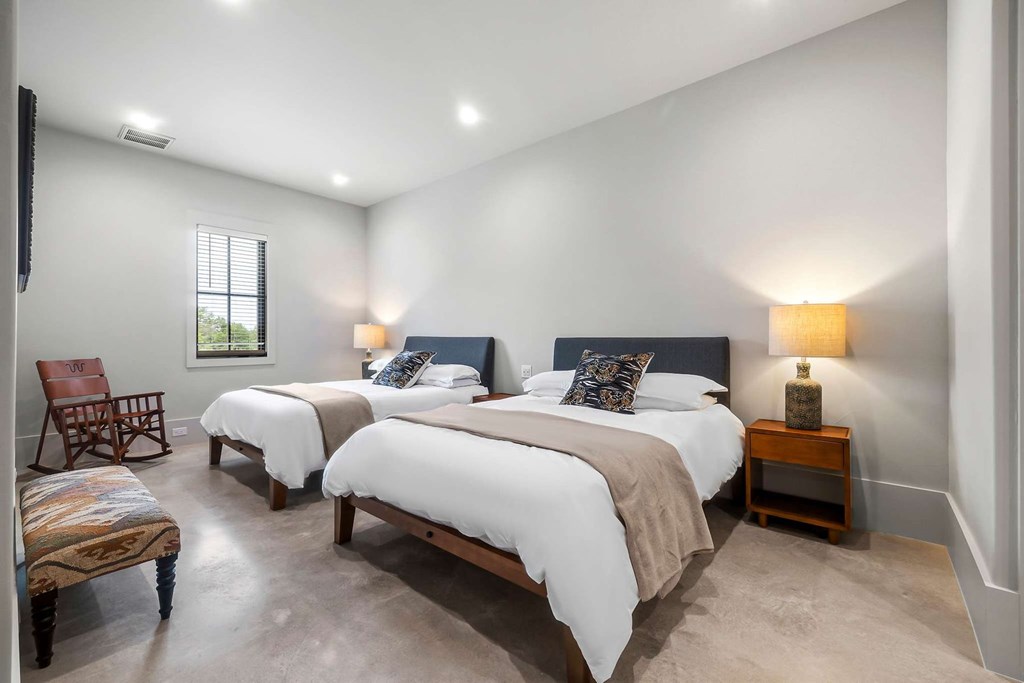 371 Achtzehn Road Fredericksburg, TX 78624 - Photo 38 of 41 a spacious bedroom with two beds and a couch