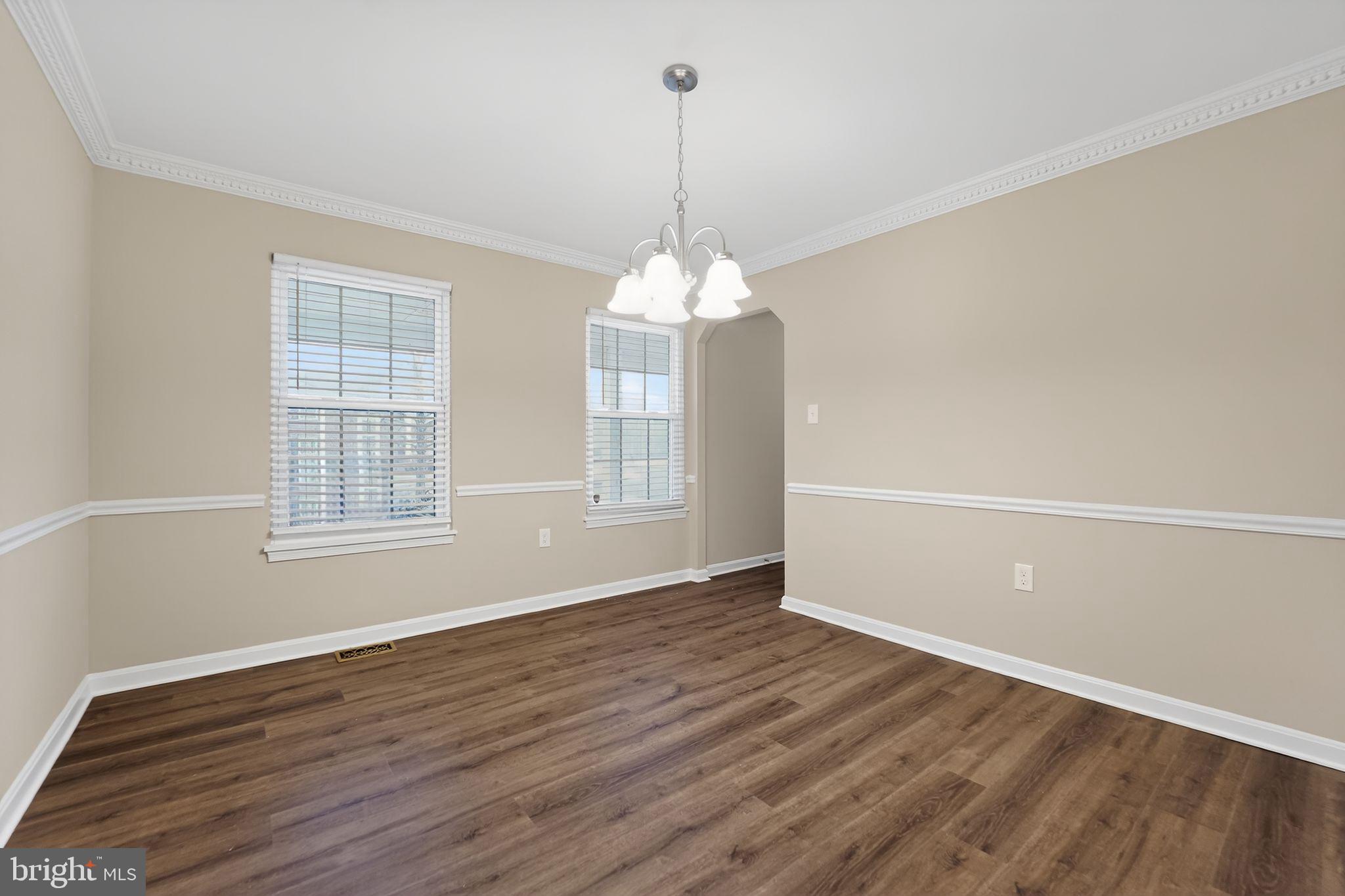 5904 Mardella Boulevard Clinton, MD 20735 - Photo 11 of 34 an empty room with wooden floor and windows