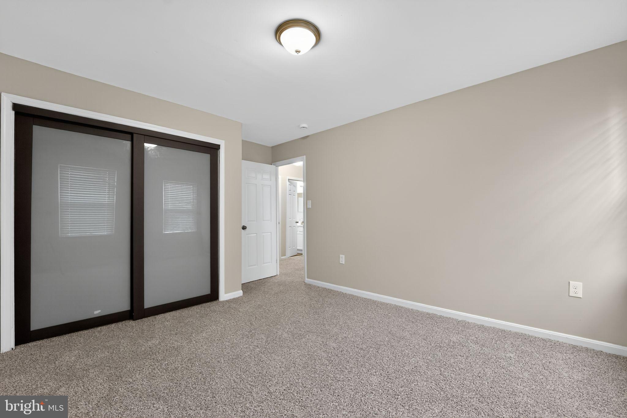 5904 Mardella Boulevard Clinton, MD 20735 - Photo 22 of 34 an empty room with closet area and mirror
