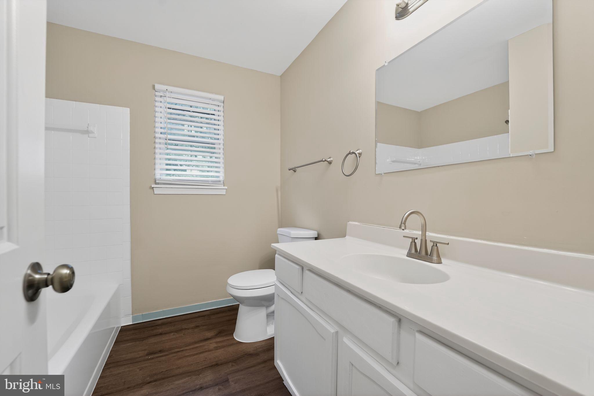 5904 Mardella Boulevard Clinton, MD 20735 - Photo 24 of 34 a bathroom with a sink a toilet and a mirror