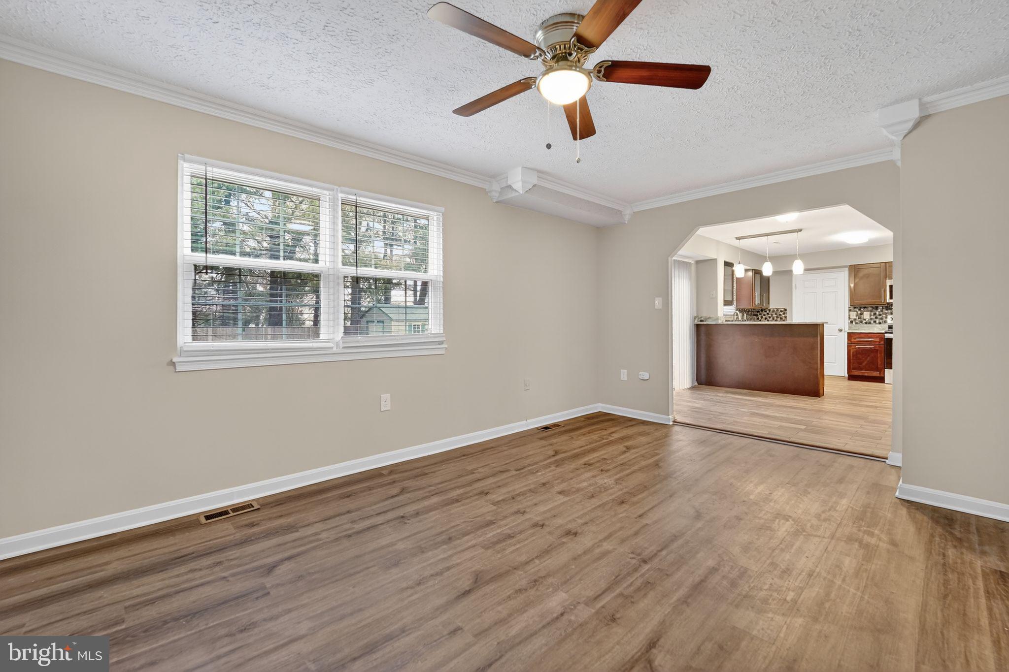 5904 Mardella Boulevard Clinton, MD 20735 - Photo 3 of 34 a view of an empty room with a window and wooden floor