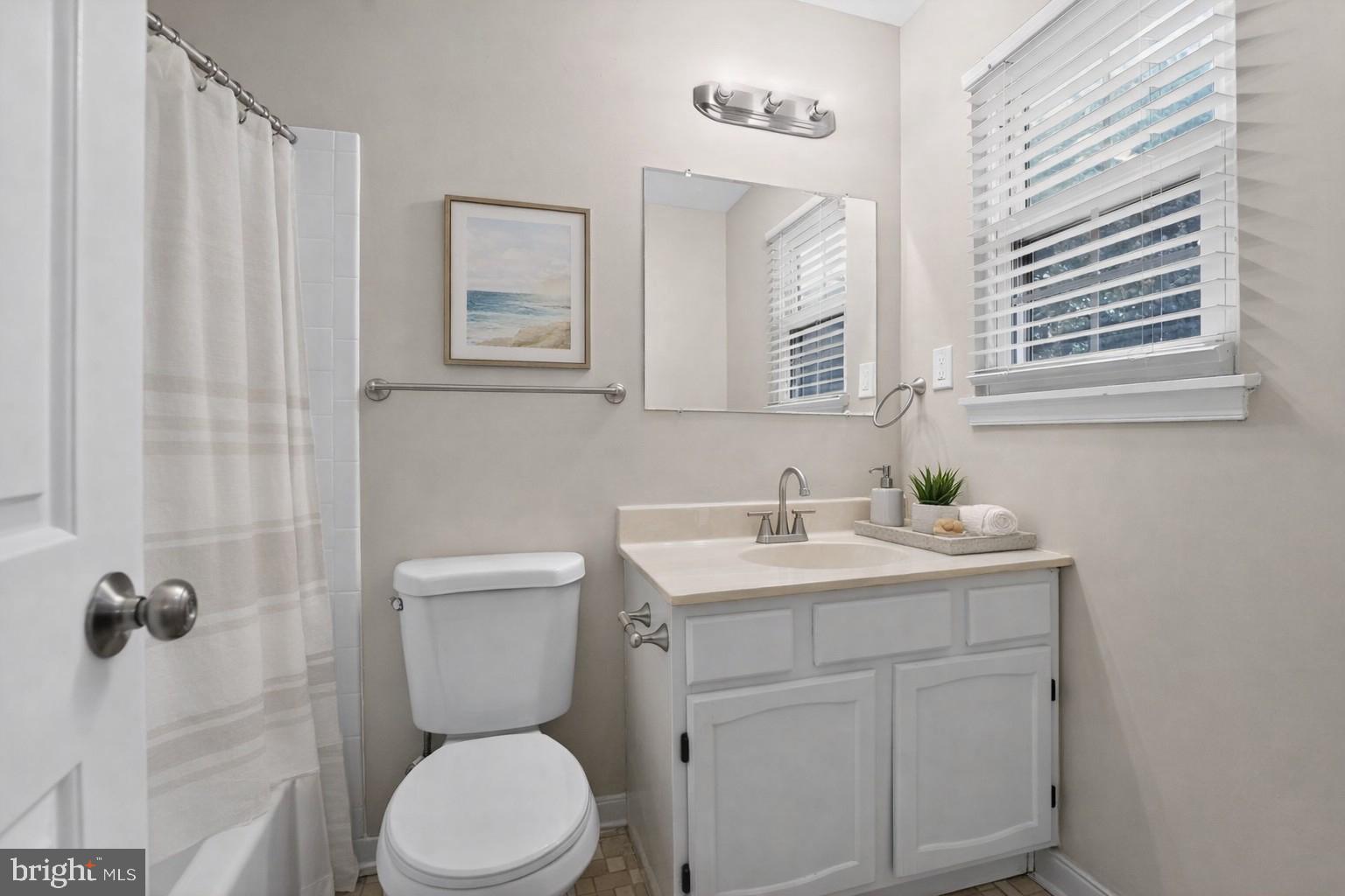 5904 Mardella Boulevard Clinton, MD 20735 - Photo 32 of 34 a bathroom with a toilet a sink and mirror