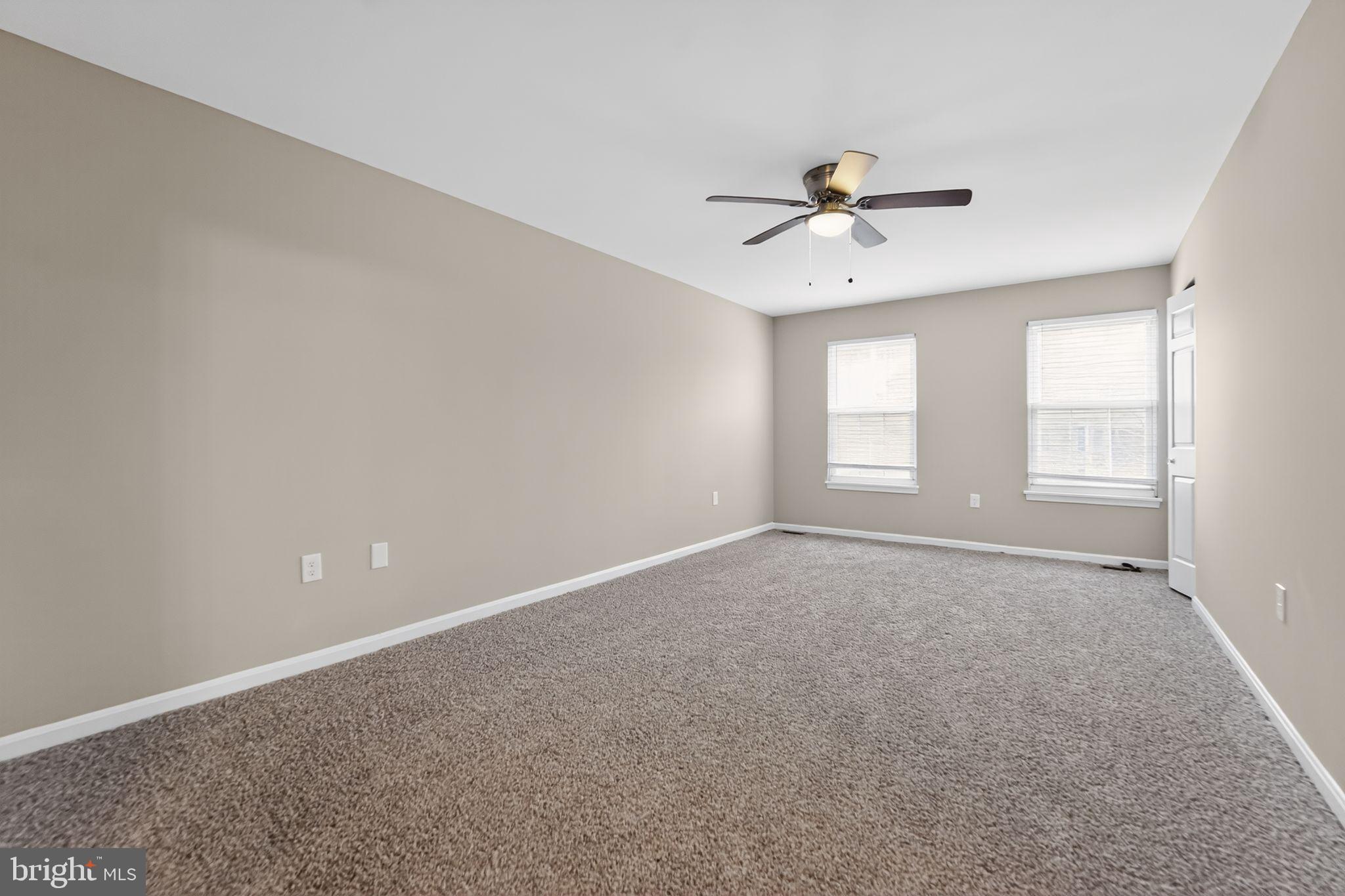 5904 Mardella Boulevard Clinton, MD 20735 - Photo 7 of 34 an empty room with windows and fan
