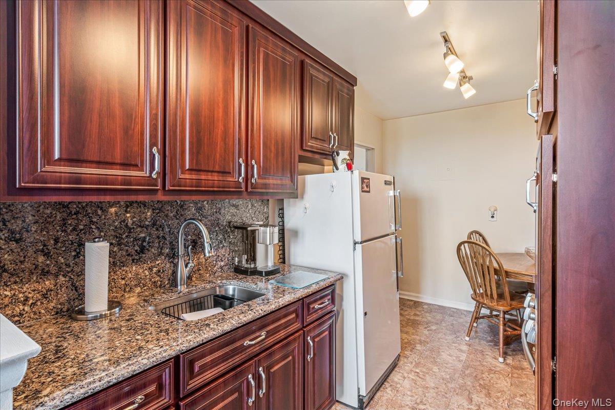 151-05 Cross Island Parkway, Unit 6C Queens, NY 11357 - Photo 12 of 20 a kitchen with stainless steel appliances granite countertop a refrigerator and a sink
