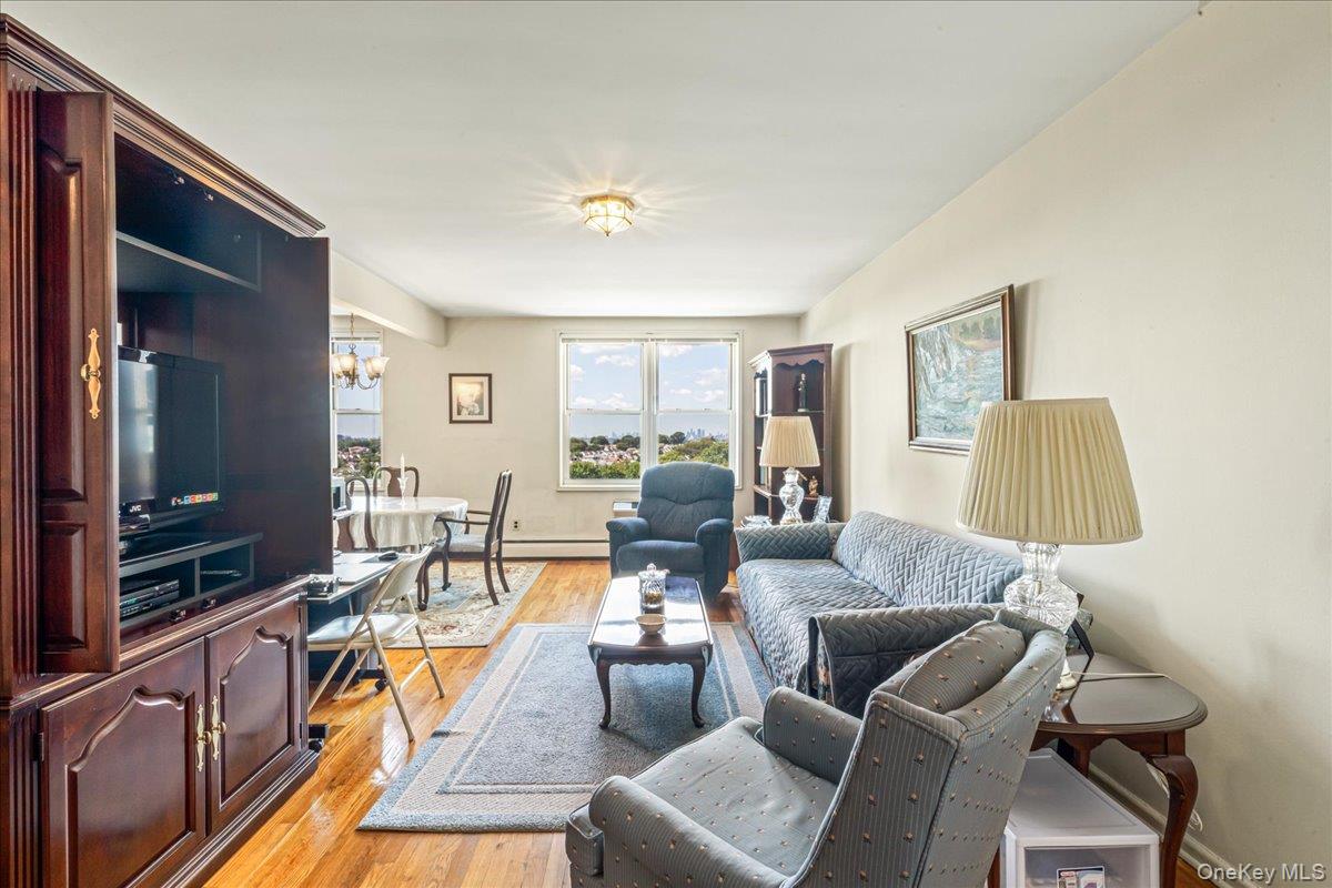 151-05 Cross Island Parkway, Unit 6C Queens, NY 11357 - Photo 4 of 20 a living room with furniture and a flat screen tv