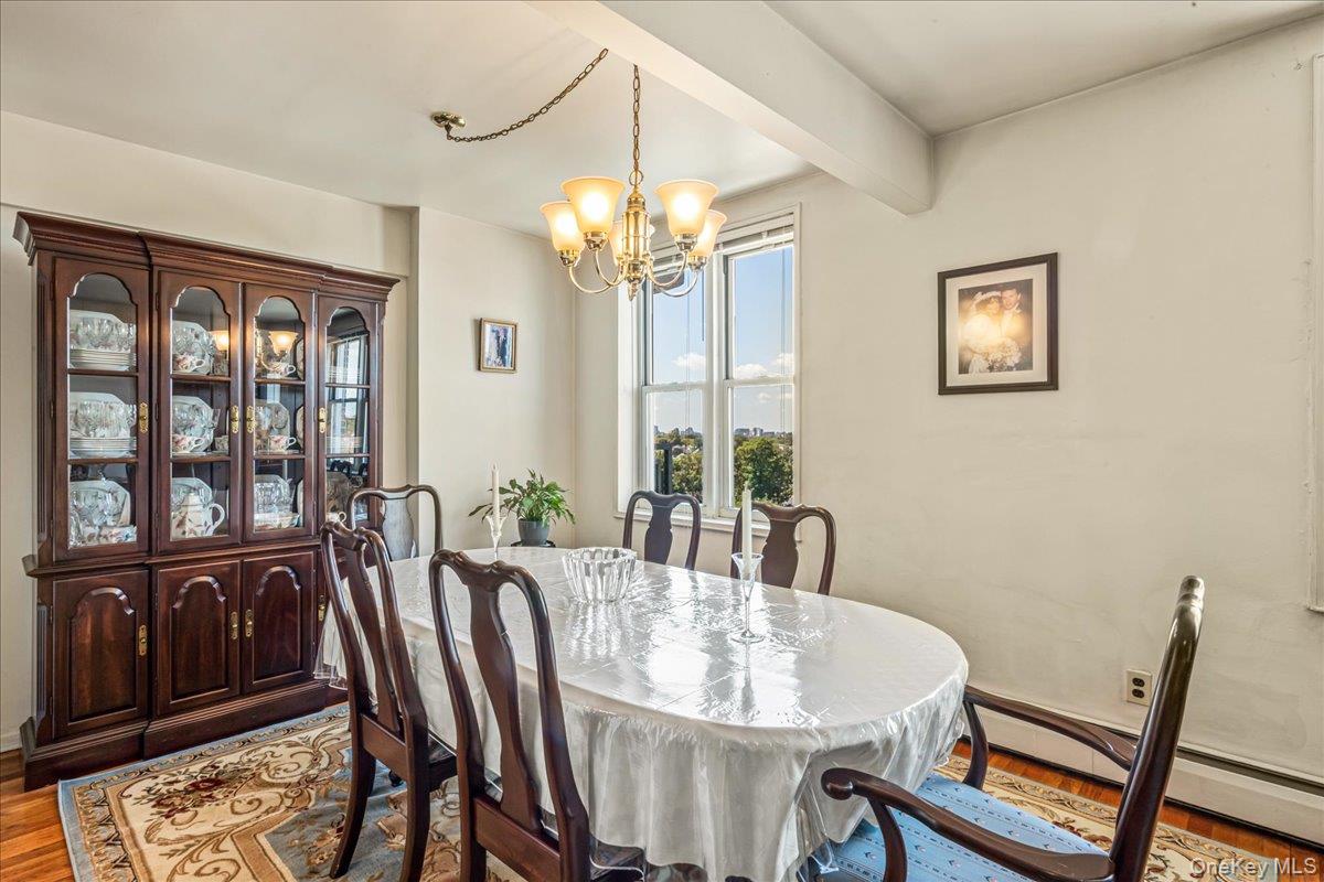 151-05 Cross Island Parkway, Unit 6C Queens, NY 11357 - Photo 8 of 20 a view of a dining room with furniture window and wooden floor