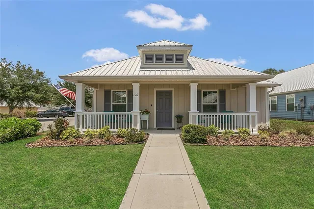 a front view of a house with a garden