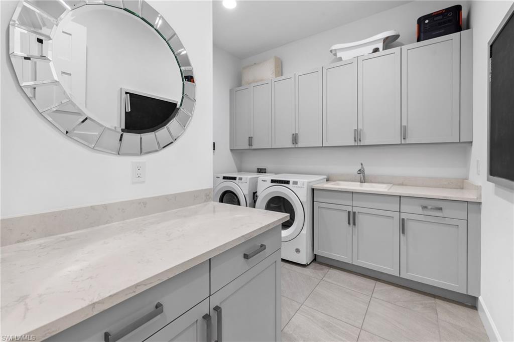 6291 Arriba Avenue Naples, FL 34113 - Photo 11 of 43 a kitchen with a sink and a stove