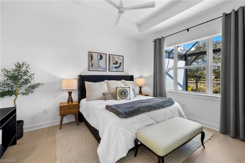 6291 Arriba Avenue Naples, FL 34113 - Photo 12 of 43 a bedroom with a bed and a potted plant