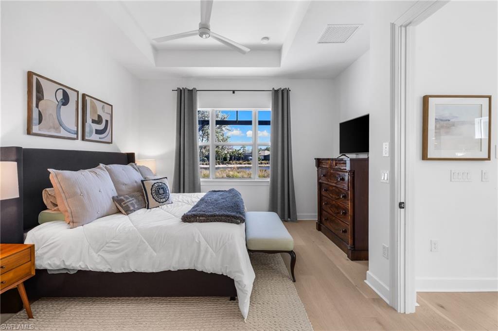 6291 Arriba Avenue Naples, FL 34113 - Photo 13 of 43 a bedroom with a bed and a television