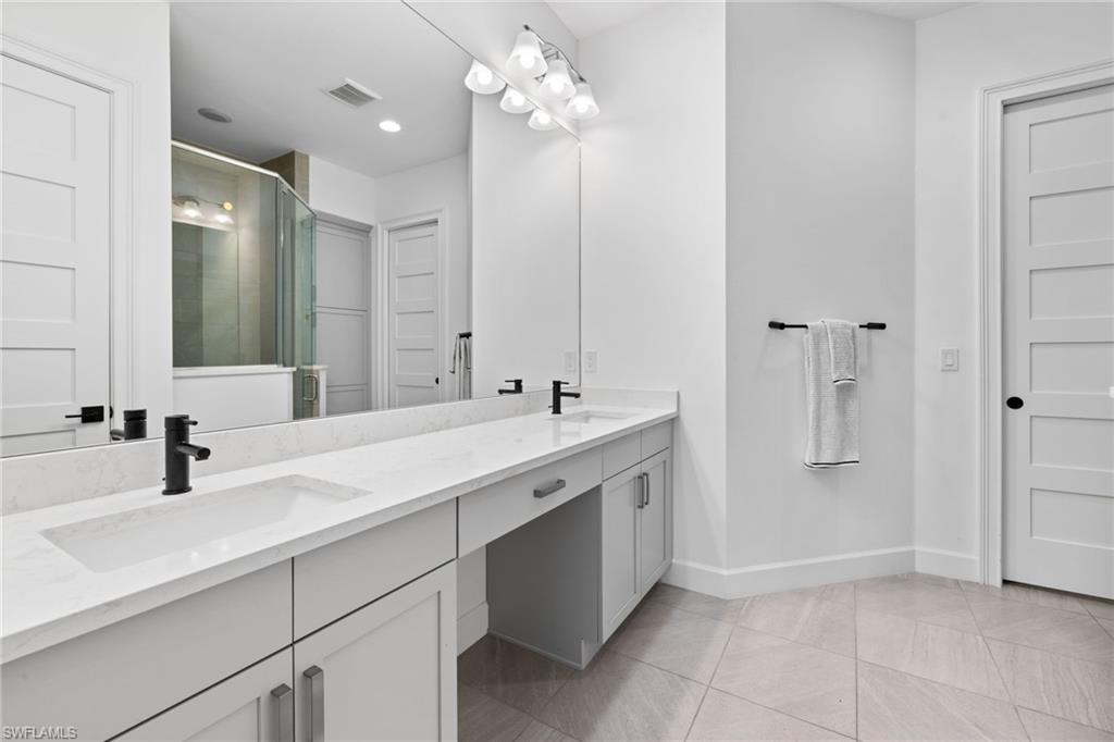 6291 Arriba Avenue Naples, FL 34113 - Photo 14 of 43 a bathroom with a double vanity sink mirror and shower