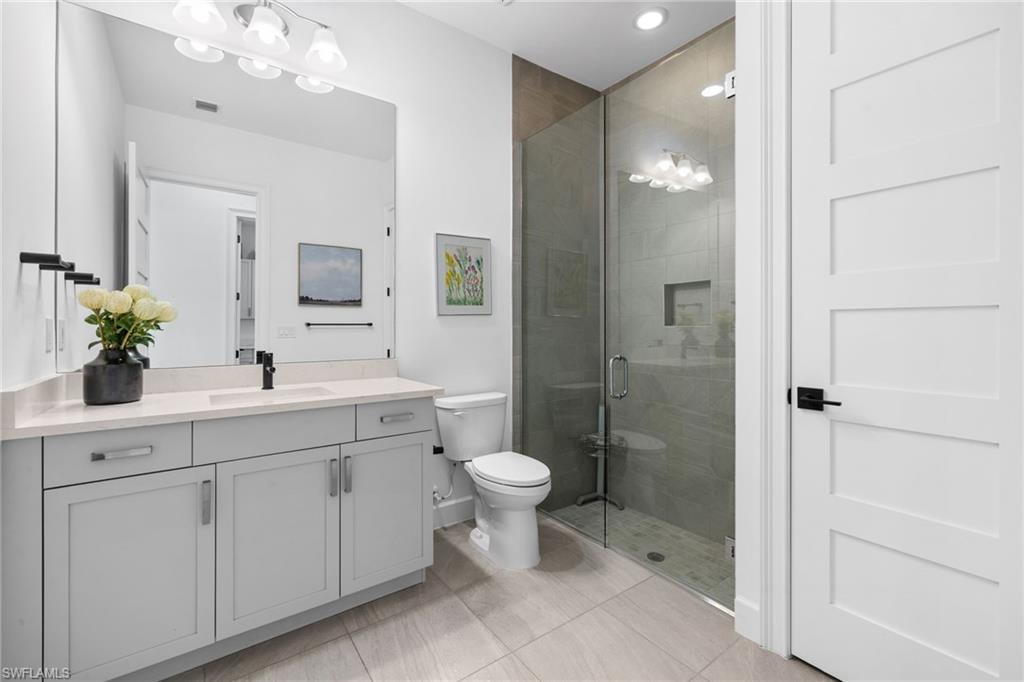 6291 Arriba Avenue Naples, FL 34113 - Photo 16 of 43 a bathroom with a sink toilet and shower